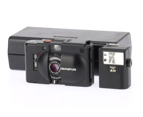 An Olympus XA 35mm Compact Camera black, body G, evidence of previous battery leak, shutter works, aperture works, internal m