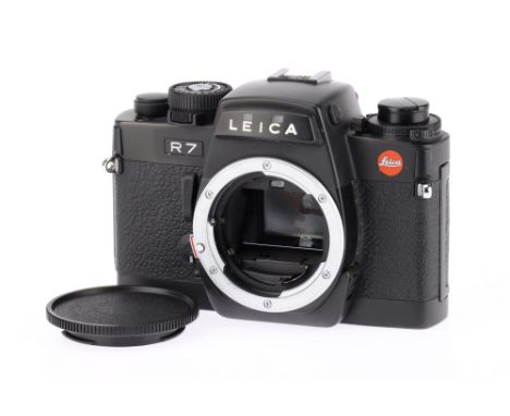 A Leica R7 35mm SLR Camera Body black, body G-VG, with batteries inserted all shutter speeds work but the mirror is slow to o