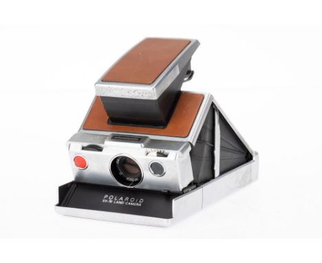 A Polaroid SX-70 Land Camera brown, body G, opens and closes correctly, not tested.