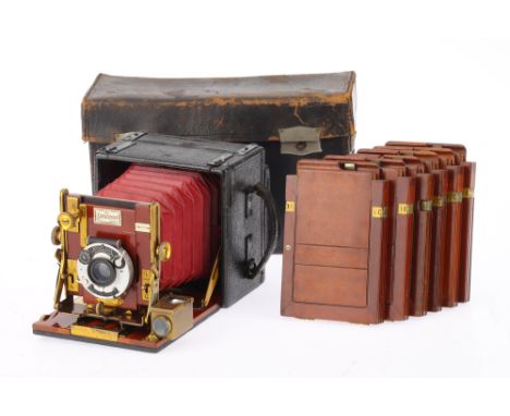 A Sanderson Hand and Stand Folding Camera, black leather, body G, red bellows extend correctly, not light tested, prism finde