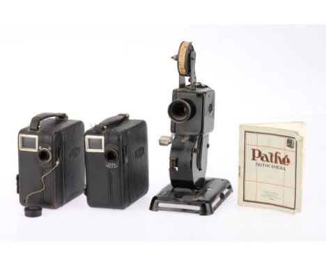 A Pair of Pathescope Cine Cameras black, bodies F-G, lenses P with haze, motors run when wound, one has a film cassette, and 