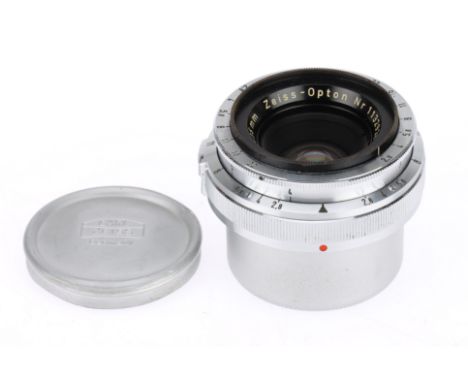 A Zeiss-Opton Biogon T f/2.8 35mm Camera Lens silver, serial 1132928, barrel VG, optics G with light dust, with metal caps.