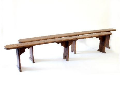 A pair of elm benches, on three uprights with bracket supports, 250cm long