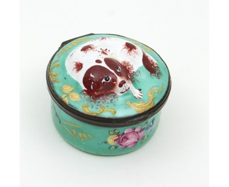 A Bilston enamel circular patch box, late 18th Century, the hinged cover with moulded decoration of a recumbent spaniel and e