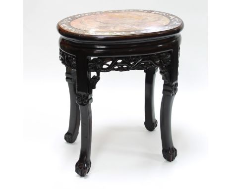 A Chinese hardwood oval jardinière stand with inset marble top and inlaid mother-of-pearl border, having a pierced and carved
