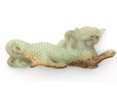 A Chinese white and russet jade carving of a dragon, 14.4cm long