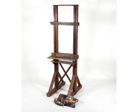 A pine framed artist's easel, 183cm high and two artist's palettes