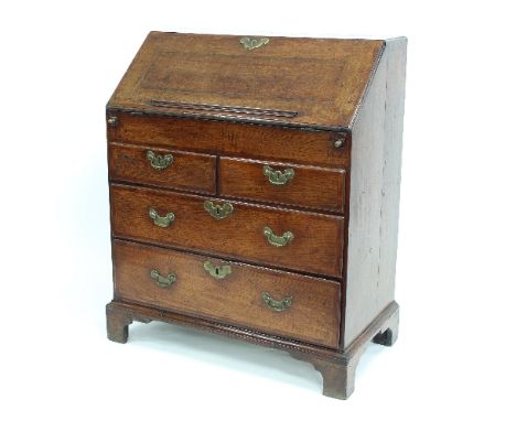A George II oak bureau fitted drawers, secret drawer cupboard and pigeon holes beneath, on bracket feet, 91cm wide Condition 