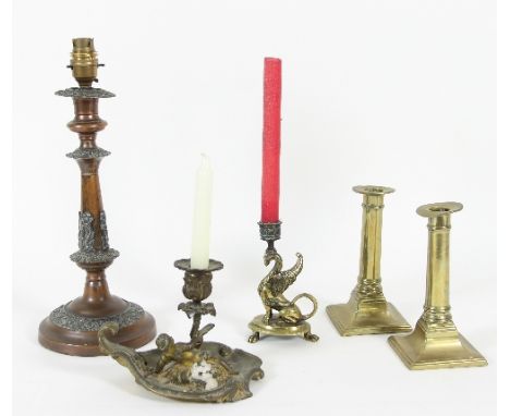 A 19th Century gilt metal chamber stick, a cherub supporting the reeded column within a c scroll border, 12.5cm high, another