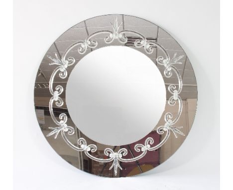 A large circular mirror, the mirrored surround decorated with clear glass fleur-de-lis and scrolls, 130cm diameter