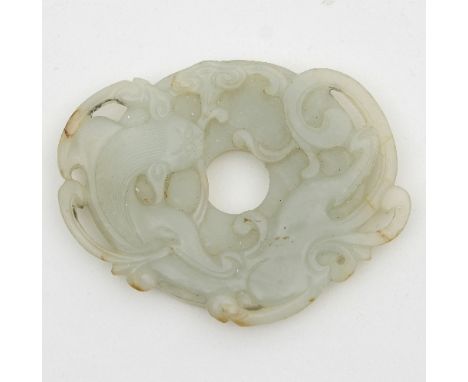 A Chinese jade Bi disc carved with a swirling dragon to one side and raised circular dots to the other, 7cm diameter 