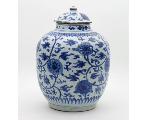 A Chinese blue and white jar and cover, late Ming circa 1640, with stiff leaf decoration to the neck above foliate scroll dec