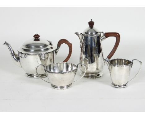 An Art Deco three-piece silver tea set, Deakin & Francis, Birmingham 1931, comprising teapot, jug and sugar basin of circular