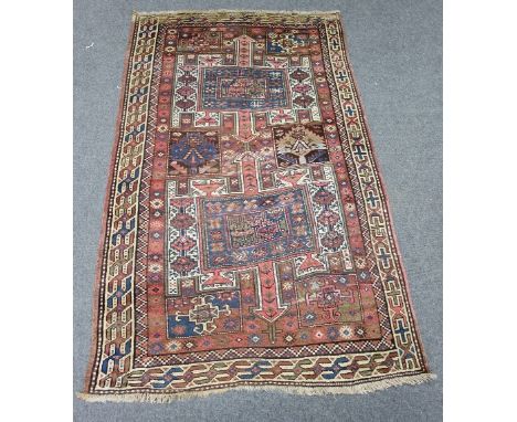 A Kazak rug with double pole medallion on a geometric ground and border, 260cm x 150cm