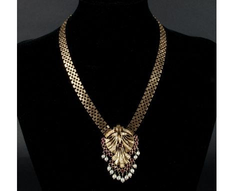 A ruby and seed pearl pendant necklace, the pendant of stylised peacock tail design with central ruby, rubies to the feather 