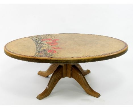 John Cleal Workshop Wales, Fishguard: a coffee table, the leather covered oval top decorated with poppies and Celtic designs,