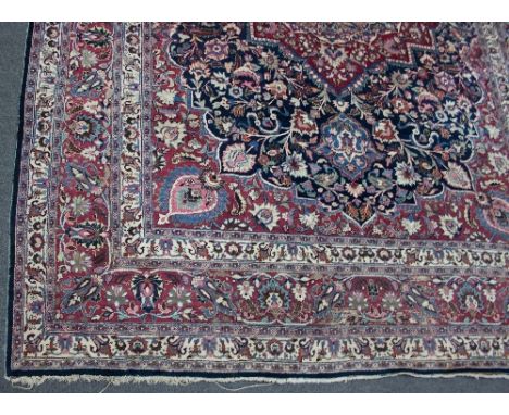 A large Kashan carpet, the central medallion on an indigo ground to a multiple border, 350cm x 520cm Condition Report: Centra