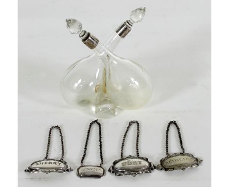 A silver mounted clear glass bottle set for oil and vinegar, Birmingham 1905, of cross over form with cut glass stoppers, fou
