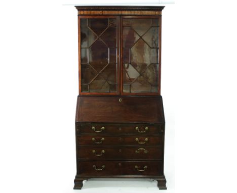 A mahogany and inlaid bureau bookcase, the associated bookcase with inlaid frieze and enclosed by astragal glazed panel doors