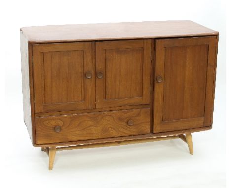 An Ercol elm sideboard, fitted a single panel door, a pair of panel doors and a single long drawer, on four tapered feet unit