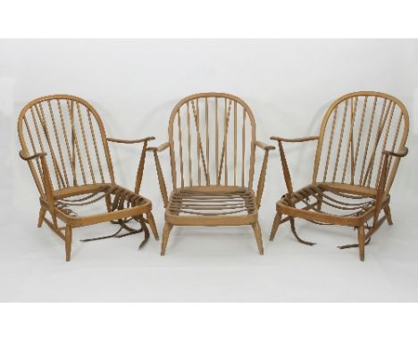 Three Ercol low Windsor type beech armchairs, each with deep seats and spindle backs, webbing straps to seat