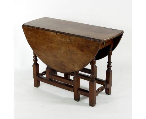 A early 18th Century walnut oval two-flap gate leg table, fitted a drawer on baluster turned legs and stretchers, 100.5cm wid