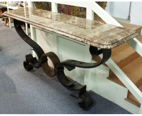 A pair of very large wrought iron console tables, the scrolling supports with mottled brown marble tops, 176cm wide Condition