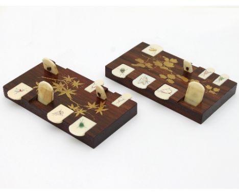 A pair of Japanese shibayama whist counters, the wooden base decorated with gilt lacquer foliage to centre, the ivory markers