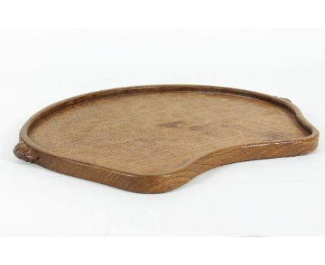 Robert 'Mouseman' Thompson (British 1876-1955): An oak tray, kidney shaped and carved with two mice to either edge, 46.5cm wi