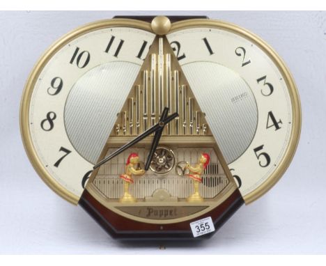 Seiko first generation Puppet clock QRE 504B, with autonomous movement behind the circular dial, which opens on the chime, wo