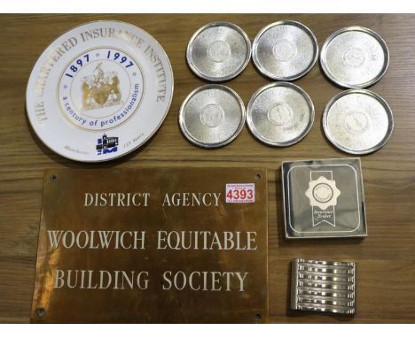 Vintage brass Woolwich Equitable plaque, with other insurance company items, including six Independent Insurance Co white met
