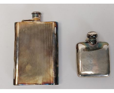 Two lockable silver hip flasks, one with an engine turned design ands the other square. H.15.6 W.10 cm (largest). Combined we