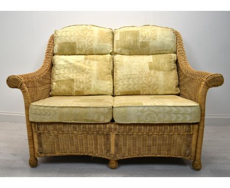 A contemporary wicker two seater conservatory sofa with four loose cushions. H.98 W.135 D.63cm 