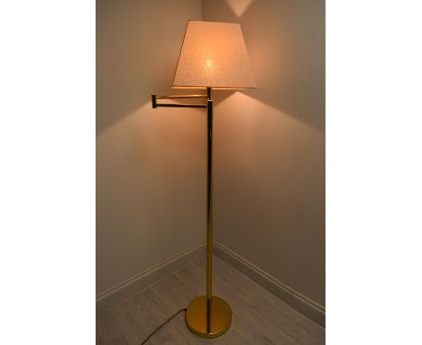 A contemporary brass plated standard lamp with adjustible arm with extension and shade raised on circular foot. H.136.5 Shade
