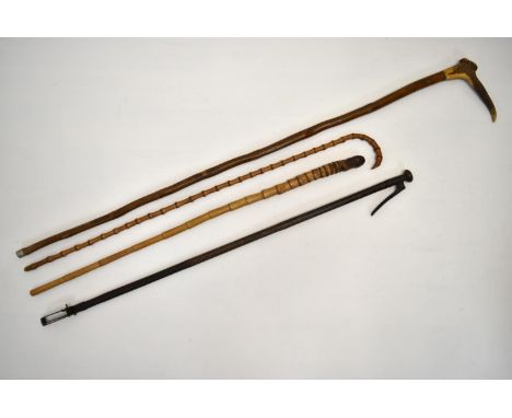 An early 20th century bamboo effect walking stick, together with a shepherds crook, a bamboo effect thumb stick and one other