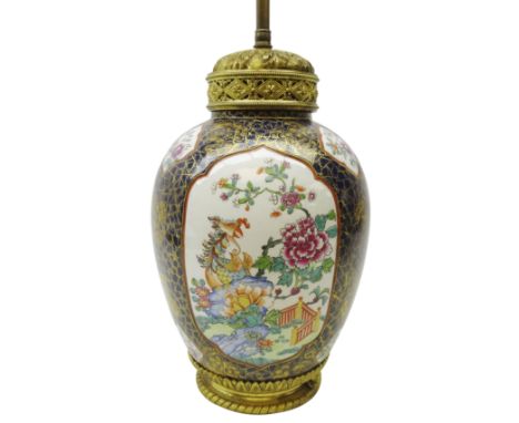 Early 20th century gilt metal mounted French porcelain table lamp, ovoid body enamelled with panels of Oriental style exotic 