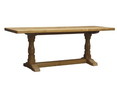 'Mouseman' rectangular adzed coffee table, two octagonal supports joined by floor chamfered stretcher, on arched sledge feet,