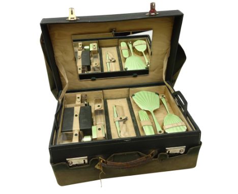 1940's green leather travelling vanity case, the satin lined interior housing a pull-out folding tray containing a four piece