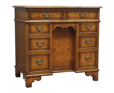 George ll style walnut kneehole desk, rectangular top with leather inset, eight drawers and small frieze drawer, single cupbo