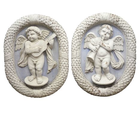 Pair of large early 20th century mahogany oval plaques carved and white painted in Wedgwood Jasper style as winged cherubs wi