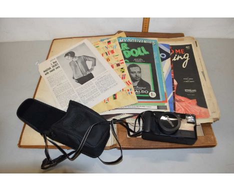 A folder of various vintage sheet music and ephemera