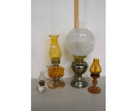 Group of three various oil lamps and a candlestick with shade
