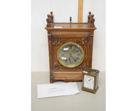 A late 19th Century German mantel clock set in a Gothic carved case together with a further small brass carriage clock