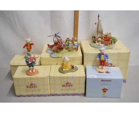 Royal Doulton collection of Rupert the Bear porcelain models to include Rupert Takes a Flying Lesson, Captain Rupert and four