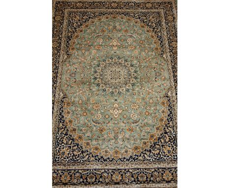 Keshan motif carpet / wall hanging, central rosette over pale green ground all over floral pattern spandrels, floral boarders