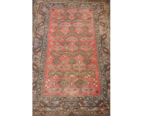 Persian carpet, allover geometric design with guls and dog tooth, over pink ground and borders, 296cm x 204cm Condition Repor