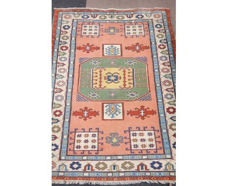 Turkish carpet central medallion with guls over pink ground further panels geometric boarders, 280cm x 213cm Condition Report