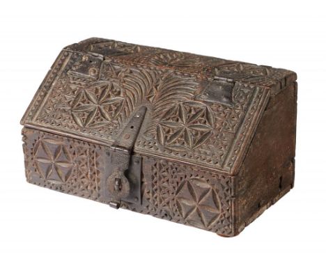 A NORTHERN EUROPEAN CHIP CARVED OAK CASKET, 17TH C  of boarded construction, the front, top and sloping lid with stylised flo