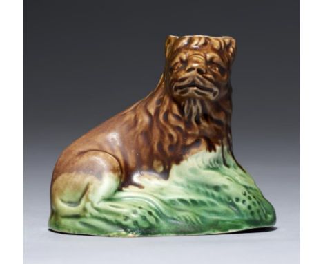 A STAFFORDSHIRE CREAMWARE MODEL OF A LION, C1780-1800 decorated in coloured glazes, 6cm h++Some professional restoration 