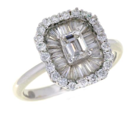 A DIAMOND CLUSTER RING  with larger central emerald cut diamond, in white gold marked 18K and DO 41 4g, size K½  ++Slight wea